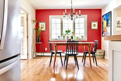 a dining room with a red wall and a table and chairs at Relaxing Hudson Valley Getaway- 4BR Sauna 15 acres in Stone Ridge