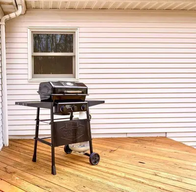 a grill on a cart in front of a house at Relaxing Hudson Valley Getaway- 4BR Sauna 15 acres in Stone Ridge
