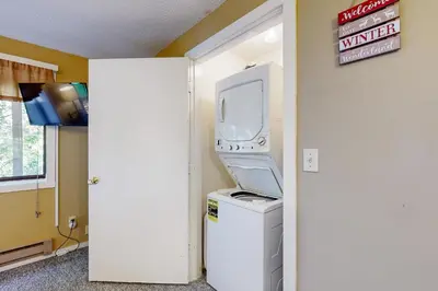 a machine sitting on top of a washing machine in a room at Dover Green 15F in Dover