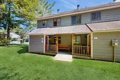 a large house with a porch and a deck at Dover Green 15F in Dover