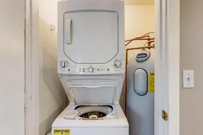 a washer and dryer in a small room with a door at Dover Green 15F in Dover