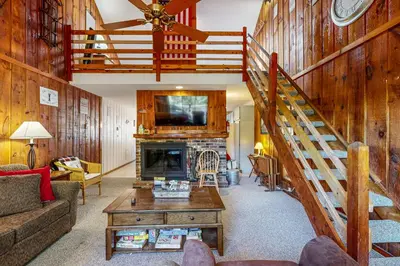 a living room with a staircase and a fireplace at Dover Green 15F in Dover