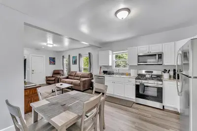 a kitchen with white cabinets and a table with a tableablish at Pitcher's Paradise Apt 1-All Star Baseball Rentals in Oneonta