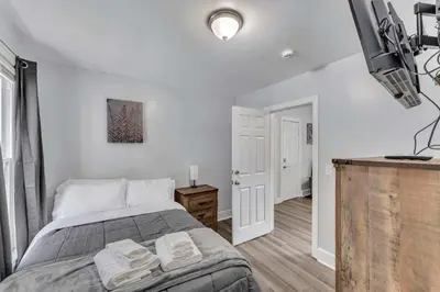 a bedroom with a bed with two towels on it at Pitcher's Paradise Apt 1-All Star Baseball Rentals in Oneonta
