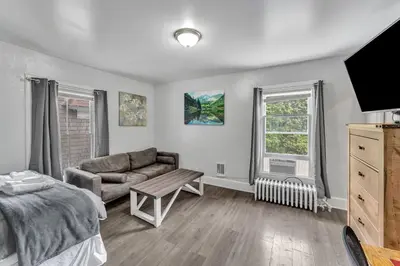 a living room with a couch and a tv at Pitcher's Paradise Apt 2-All Star Baseball Rentals in Oneonta