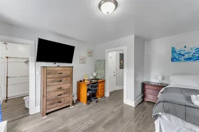 a bedroom with a bed and a flat screen tv at Pitcher's Paradise Apt 2-All Star Baseball Rentals in Oneonta
