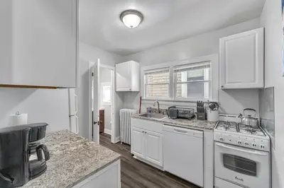 a kitchen with white cabinets and a stove top oven at Pitcher's Paradise Apt 2-All Star Baseball Rentals in Oneonta