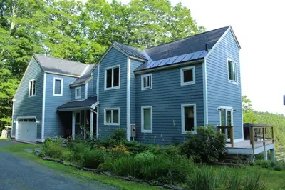 a blue house with a gambrel roof at Vermont Ski Home Lake Home in Jacksonville