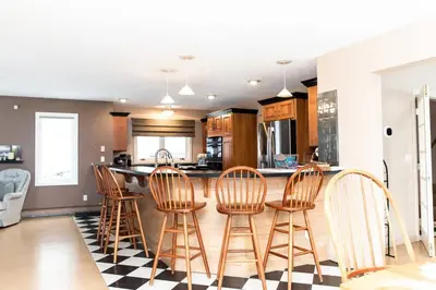 a kitchen with a black and white checkered floor at Vermont Ski Home Lake Home in Jacksonville