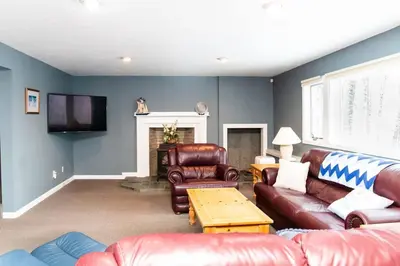 a living room with leather furniture and a fireplace at Vermont Ski Home Lake Home in Jacksonville