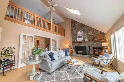 a living room with a couch and a fireplace at Vermont Ski Home Lake Home in Jacksonville