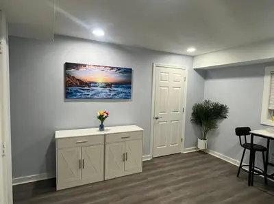 a room with a table and a painting on the wall at Charming Unit in Yonkers Close to NYC in Yonkers