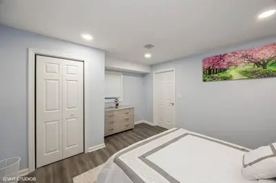 a bedroom with a bed and a painting on the wall at Charming Unit in Yonkers Close to NYC in Yonkers