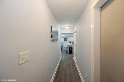 a hallway with white walls and wooden floors and a room at Charming Unit in Yonkers Close to NYC in Yonkers