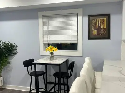 a dining room with a table with chairs and a window at Charming Unit in Yonkers Close to NYC in Yonkers