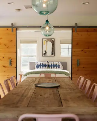 a dining room with a wooden table and chairs at Stunning All-Season Renovated Barn Escape! in East Chatham