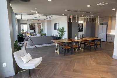a dining room with a large wooden table and chairs at Modern Loft 15 Min from NYC with City View & Pool in Croxton