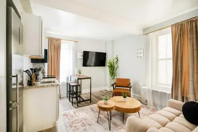 a living room with a couch and a table at 73-508 New 1BR 1Bth UWS Doorman Gym in New York