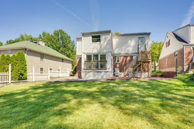 a large yard with a house and a building at 4 Mi to NYC, Shared Yard Englewood Apartment! in Englewood