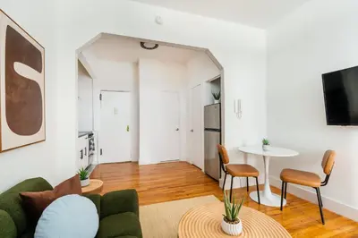 a living room with a couch and a table at 444-1A Beautiful 1BR Midtown West in New York