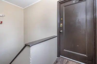 a large wooden door in a room with a staircase at Queen Bed Apt in West Hartford in West Hartford