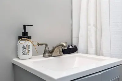 a sink with a hand sanitizer on top of it at Queen Bed Apt in West Hartford in West Hartford