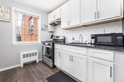 a kitchen with white cabinets and a microwave at Queen Bed Apt in West Hartford in West Hartford