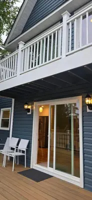 a screened in porch with a balcony on a house at Sparta lakehouse in Sparta