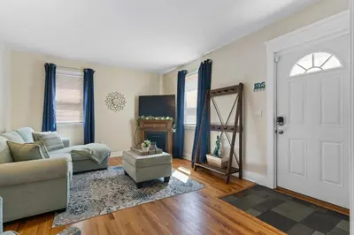 a living room with a couch and a door at UNH Home Base 10 minutes from beach in West Haven