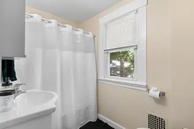a bathroom with a white shower curtain and a sink at UNH Home Base 10 minutes from beach in West Haven