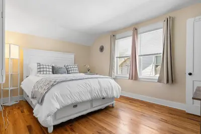 a bedroom with a white bed and two windows at UNH Home Base 10 minutes from beach in West Haven