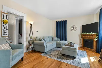 a living room with two couches and a tv at UNH Home Base 10 minutes from beach in West Haven