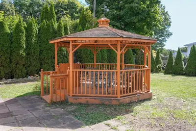 a wooden gazebo sitting in a yard at 3BR Gem, 10 min to Yale, walk to Tweed in New Haven