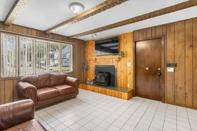 a living room with a couch and a fireplace at 3BR Gem, 10 min to Yale, walk to Tweed in New Haven
