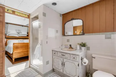 a bathroom with a sink and a toilet and a bed at 3BR Gem, 10 min to Yale, walk to Tweed in New Haven