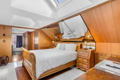a bedroom with a large bed in a boat at 3BR Gem, 10 min to Yale, walk to Tweed in New Haven