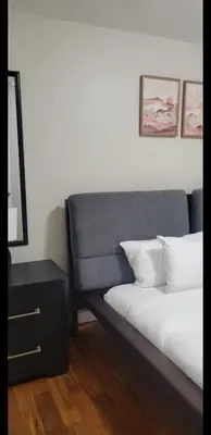 a bedroom with a bed and a nightstand next to a bed sidx sidx sidx at Exquisite 4 Beds Near EWR NYC in East Orange