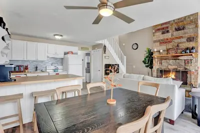 a kitchen and living room with a table and chairs at Pet Friendly! Lakefront w Hot Tub, Firepit! in Tobyhanna