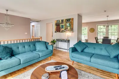 a living room with two blue couches and a table at Family Home Close to Warwick, 5 Mi to Lake! in Monroe