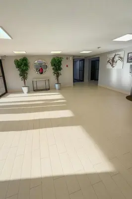a large empty room with potted plants on the wall at Floral Park Motor Lodge in Floral Park