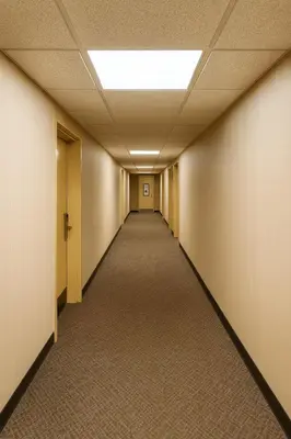 an empty hallway in an office building with a ceiling at Floral Park Motor Lodge in Floral Park