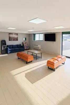 a living room with two couches and a tv at Floral Park Motor Lodge in Floral Park