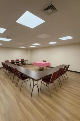a large conference room with a table and chairs at Floral Park Motor Lodge in Floral Park