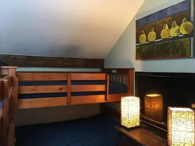 a bedroom with a bunk bed and two lights at Stratton Chalet in Stratton