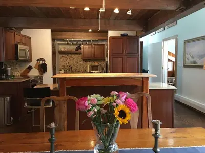 a vase of flowers on a table in a kitchen at Stratton Chalet in Stratton