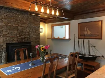 a dining room with a table with a vase of flowers at Stratton Chalet in Stratton