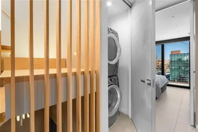 a laundry room with a washer and a washing machine at 2 Story Villa in Upper Ditmars Astoria Queens in Steinway