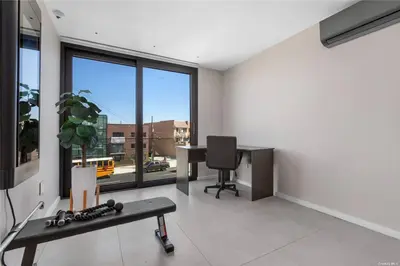 an office with a desk and a chair and window at 2 Story Villa in Upper Ditmars Astoria Queens in Steinway