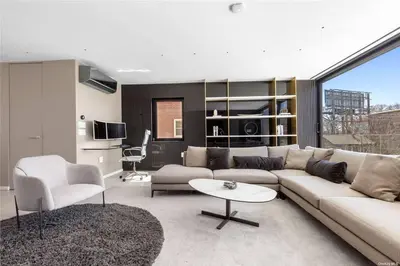 a living room with a couch and a table at 2 Story Villa in Upper Ditmars Astoria Queens in Steinway