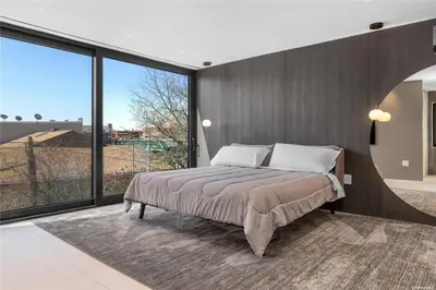 a bedroom with a large bed and a large window at 2 Story Villa in Upper Ditmars Astoria Queens in Steinway